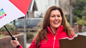 Judie McCourt holding an umbrella