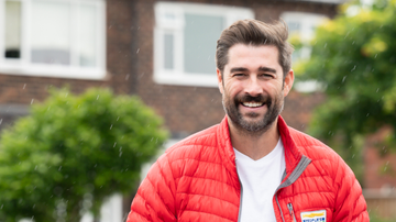 Matt Johnson standing and smiling in the rain